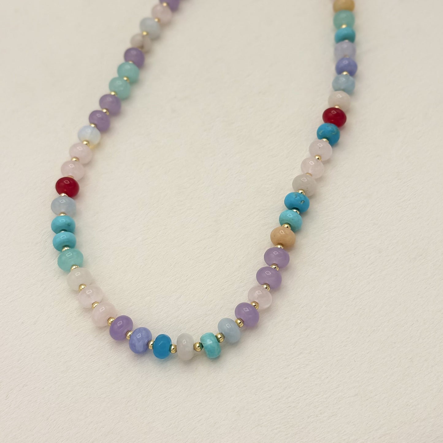 Multicolored beaded necklace on a light background
