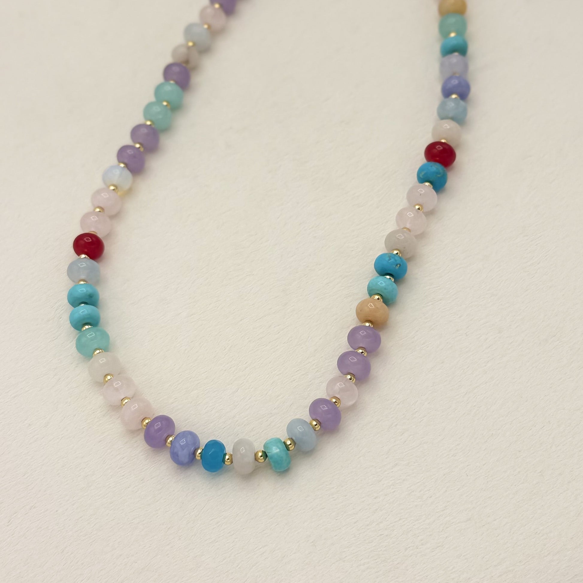 Multicolored beaded necklace on a light background